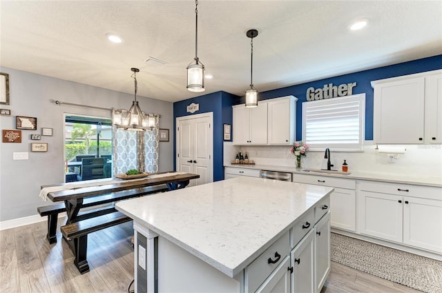 8940 Royal River Cir, Parrish, FL 34219 - kitchen featuring a sink, a kitchen island, a chandelier, dishwasher, and white cabinetry