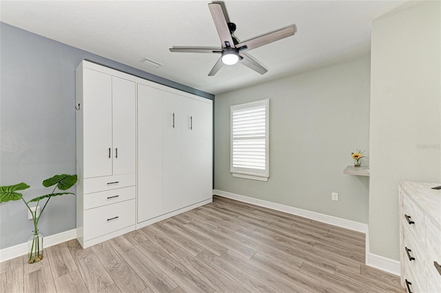 8940 Royal River Cir, Parrish, FL 34219 - unfurnished bedroom featuring light wood-style floors, baseboards, a closet, and ceiling fan