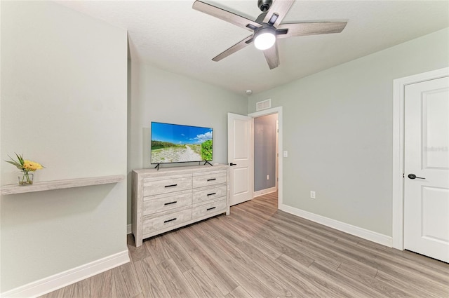 8940 Royal River Cir, Parrish, FL 34219 - unfurnished bedroom featuring light wood finished floors, baseboards, and ceiling fan