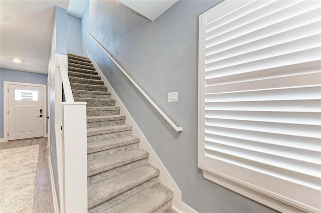 8940 Royal River Cir, Parrish, FL 34219 - staircase with baseboards and wood finished floors