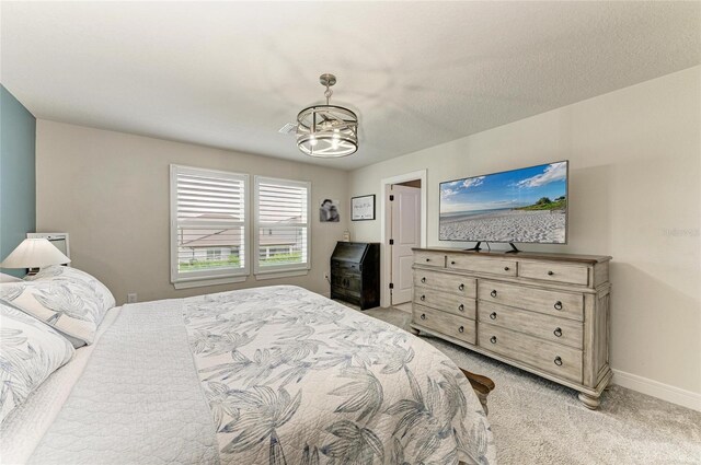 8940 Royal River Cir, Parrish, FL 34219 - bedroom featuring a chandelier, light colored carpet, and baseboards