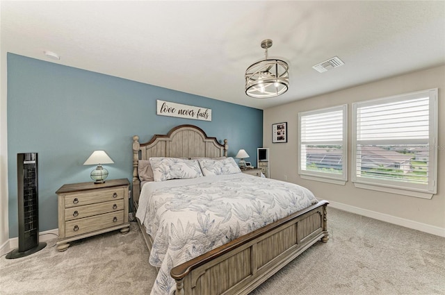 8940 Royal River Cir, Parrish, FL 34219 - bedroom featuring light carpet, baseboards, and a chandelier