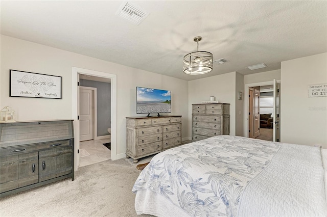 8940 Royal River Cir, Parrish, FL 34219 - bedroom featuring light colored carpet, a chandelier, connected bathroom, and baseboards