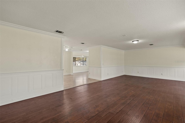 31 Twig Ct, Port Charlotte, FL 33954 - empty room featuring crown molding, hardwood / wood-style floors, a textured ceiling, wainscoting, and a ceiling fan