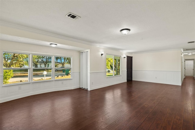 31 Twig Ct, Port Charlotte, FL 33954 - unfurnished living room with wood finished floors, crown molding, a wainscoted wall, and a textured ceiling