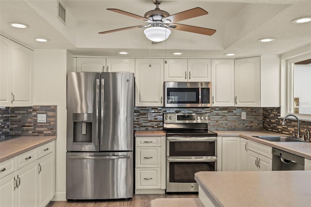 31 Twig Ct, Port Charlotte, FL 33954 - kitchen featuring stainless steel appliances, a sink, recessed lighting, a ceiling fan, and white cabinetry