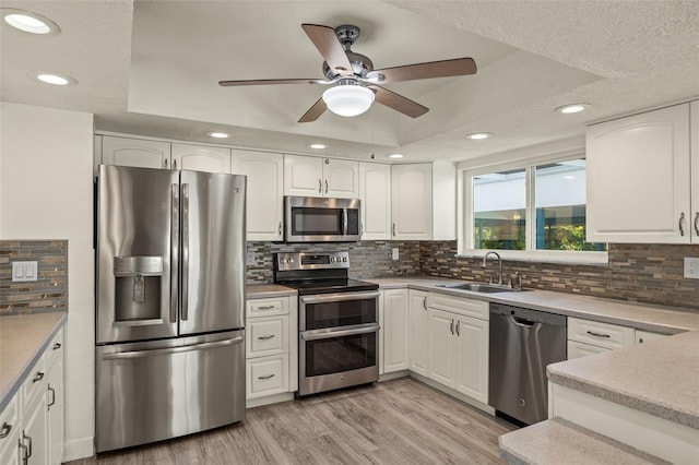 31 Twig Ct, Port Charlotte, FL 33954 - kitchen featuring stainless steel appliances, a sink, ceiling fan, tasteful backsplash, and white cabinets