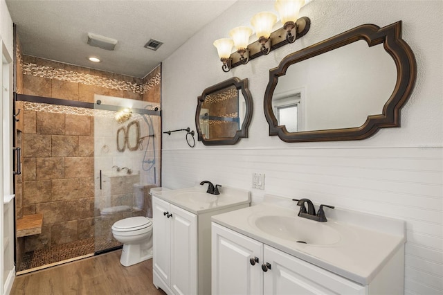 31 Twig Ct, Port Charlotte, FL 33954 - bathroom with a stall shower, toilet, two vanities, and wood finished floors