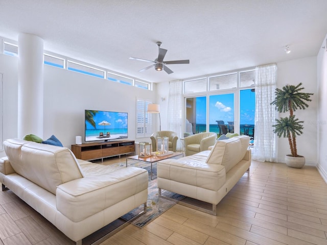 6512 Midnight Pass Rd Unit 301, Sarasota, FL 34242 - living room with ceiling fan, healthy amount of natural light, and light wood-style floors