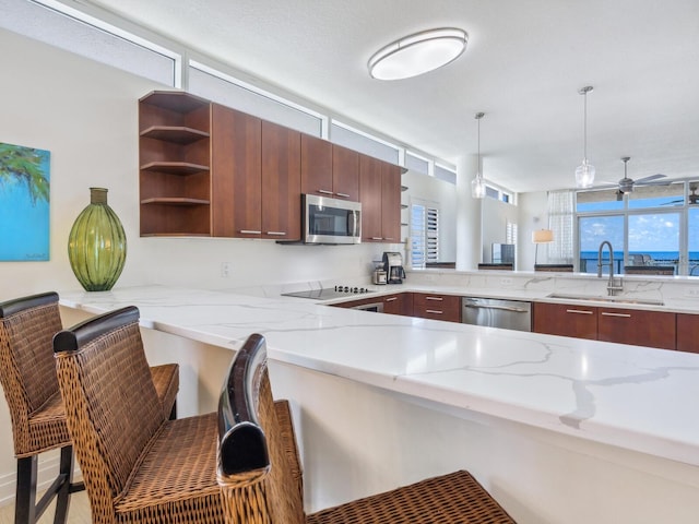6512 Midnight Pass Rd Unit 301, Sarasota, FL 34242 - kitchen with a sink, appliances with stainless steel finishes, open shelves, light stone counters, and a peninsula