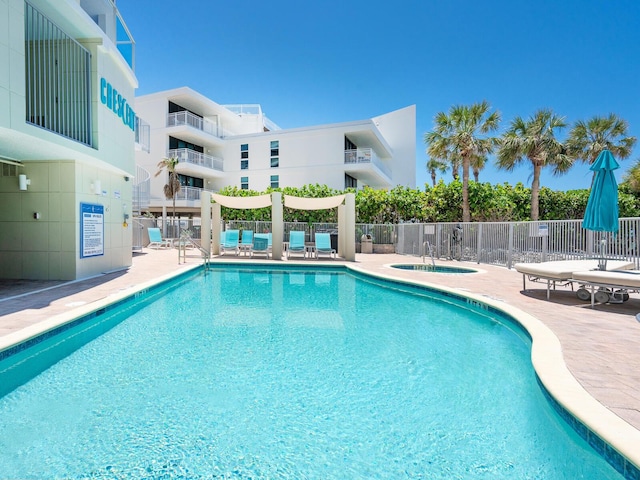 6512 Midnight Pass Rd Unit 301, Sarasota, FL 34242 - community pool featuring a community hot tub and a patio area