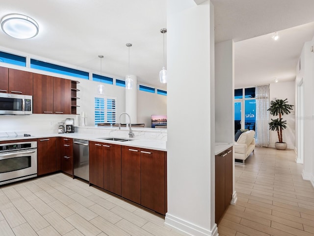 6512 Midnight Pass Rd Unit 301, Sarasota, FL 34242 - kitchen with stainless steel appliances, a sink, open shelves, and decorative light fixtures