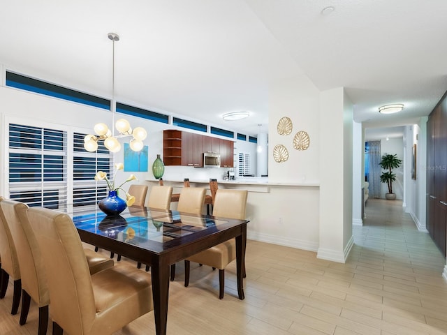 6512 Midnight Pass Rd Unit 301, Sarasota, FL 34242 - dining space featuring baseboards and a chandelier