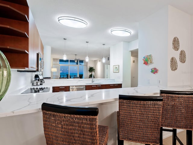 6512 Midnight Pass Rd Unit 301, Sarasota, FL 34242 - kitchen featuring stainless steel appliances, a sink, a peninsula, open shelves, and light stone countertops