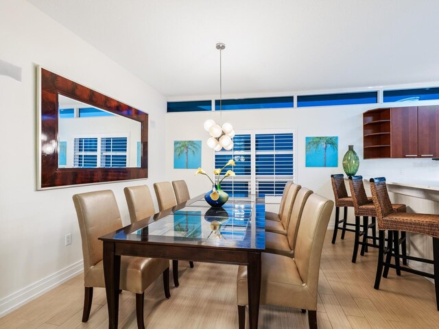 6512 Midnight Pass Rd Unit 301, Sarasota, FL 34242 - dining space with light wood-type flooring, a chandelier, and baseboards
