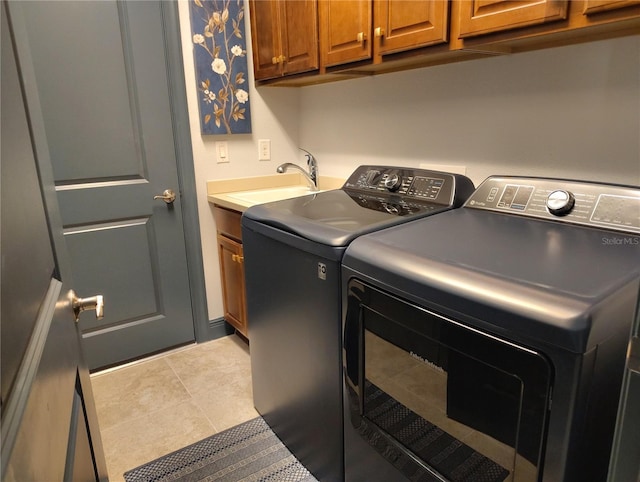 1241 Riverscape St Unit B, Bradenton, FL 34208 - washroom featuring washer and dryer, cabinet space, and tile patterned flooring