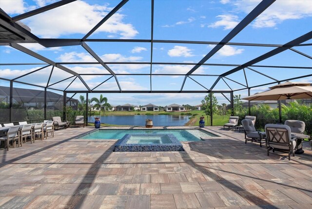 8982 Baroque Ter, Sarasota, FL 34240 - view of swimming pool featuring a patio area, a lanai, a pool with connected hot tub, and a water view