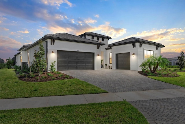 8982 Baroque Ter, Sarasota, FL 34240 - view of front of home with an attached garage, driveway, a front yard, and stucco siding