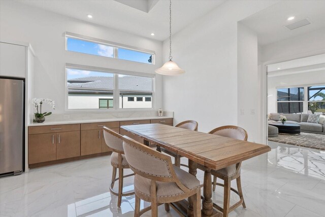 8982 Baroque Ter, Sarasota, FL 34240 - dining space featuring light marble finish floors and recessed lighting