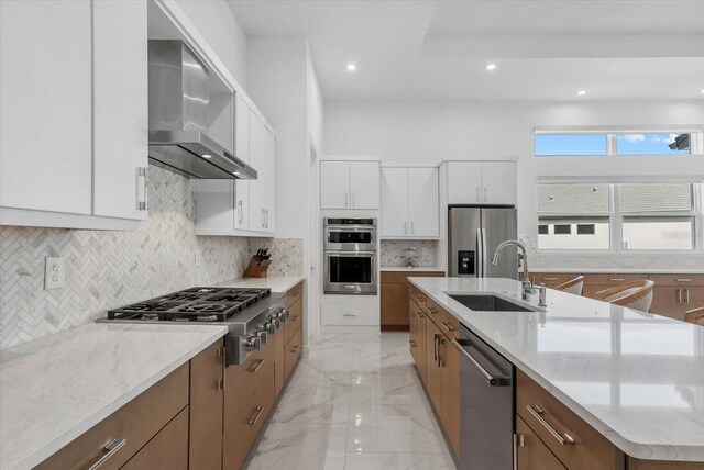 8982 Baroque Ter, Sarasota, FL 34240 - kitchen featuring wall chimney exhaust hood, a sink, stainless steel appliances, recessed lighting, and light marble finish floors