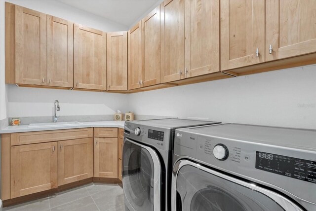 8982 Baroque Ter, Sarasota, FL 34240 - washroom featuring independent washer and dryer, cabinet space, and light tile patterned floors