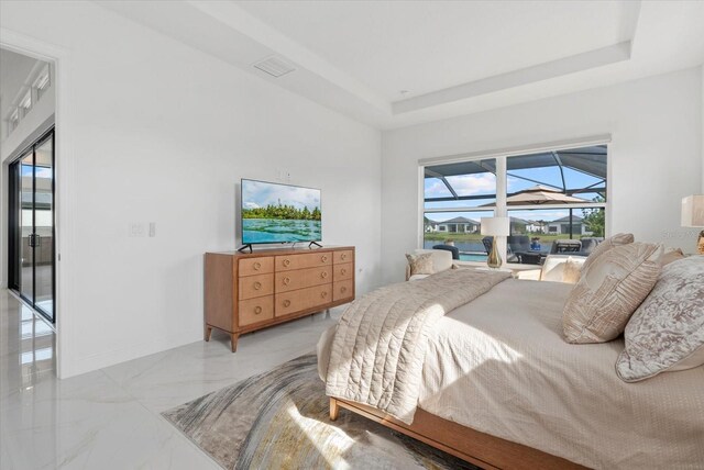 8982 Baroque Ter, Sarasota, FL 34240 - bedroom featuring light marble finish floors, a raised ceiling, access to exterior, and baseboards
