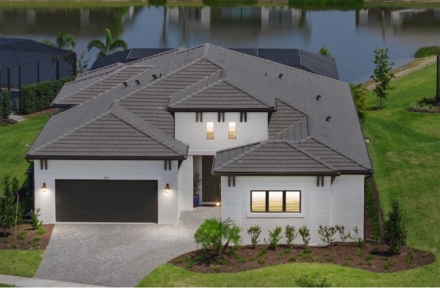 8982 Baroque Ter, Sarasota, FL 34240 - view of front of home with an attached garage, a water view, and a tile roof