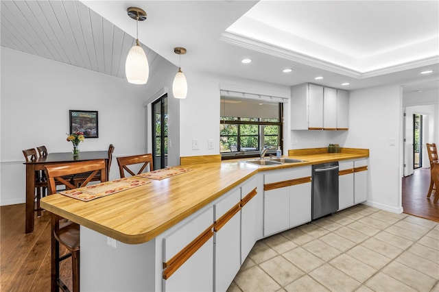 435 Whispering Oaks Ct, Sarasota, FL 34232 - kitchen with dishwasher, a sink, recessed lighting, white cabinetry, and wood counters
