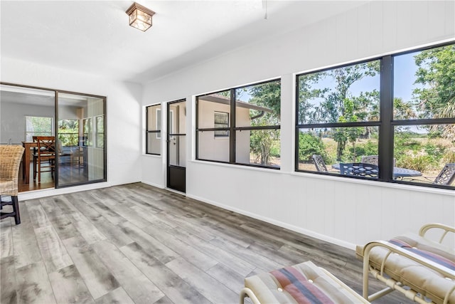 435 Whispering Oaks Ct, Sarasota, FL 34232 - unfurnished living room with wood finished floors and baseboards