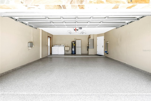 435 Whispering Oaks Ct, Sarasota, FL 34232 - garage with washer and clothes dryer, electric water heater, and a garage door opener