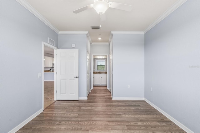 17118 Vardon Ter Unit 404, Bradenton, FL 34211 - unfurnished bedroom with ornamental molding, connected bathroom, wood finished floors, baseboards, and a ceiling fan