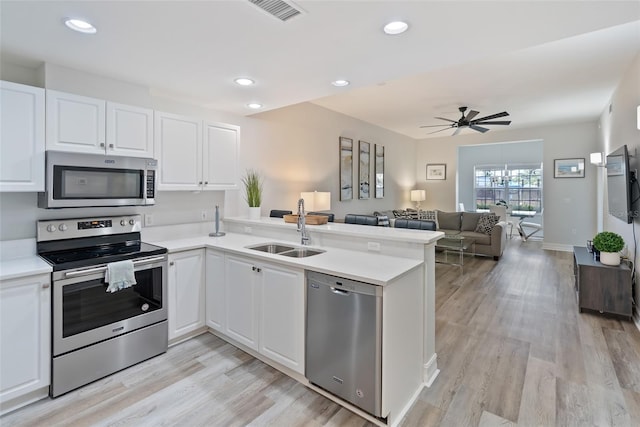 3702 54th Dr W Unit 102, Bradenton, FL 34210 - kitchen featuring stainless steel appliances, a sink, ceiling fan, a peninsula, and light countertops