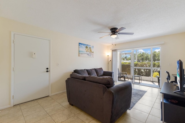 3253 Beneva Rd Unit 103, Sarasota, FL 34232 - living room featuring a ceiling fan, light tile patterned floors, baseboards, and a textured ceiling
