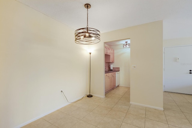 3253 Beneva Rd Unit 103, Sarasota, FL 34232 - unfurnished room with light tile patterned floors, a chandelier, a sink, and baseboards