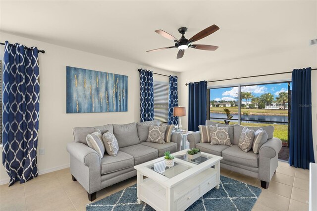 5358 Shell Mound Cir, Punta Gorda, FL 33982 - living area with ceiling fan, light tile patterned flooring, a water view, and baseboards