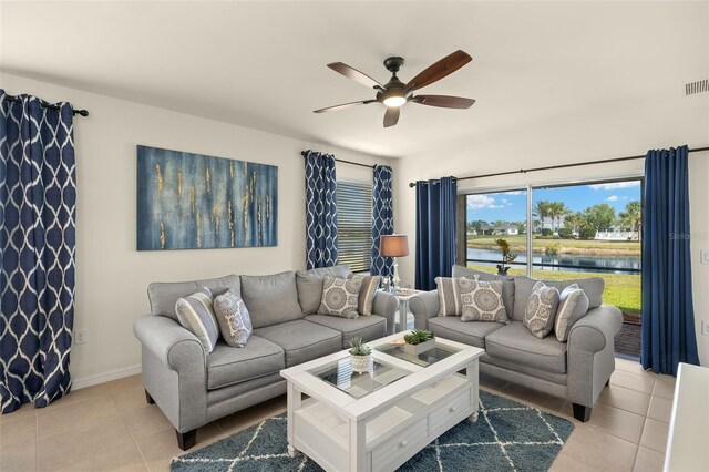 5358 Shell Mound Cir, Punta Gorda, FL 33982 - living room with ceiling fan, light tile patterned flooring, a water view, and baseboards