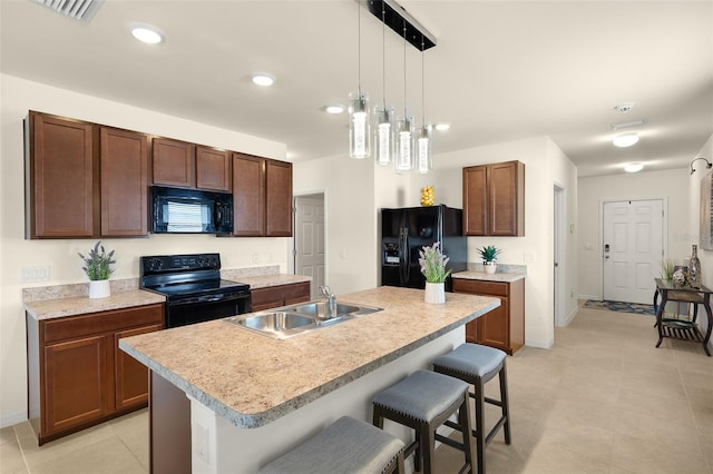 5358 Shell Mound Cir, Punta Gorda, FL 33982 - kitchen featuring black appliances, a sink, a kitchen breakfast bar, hanging light fixtures, and light countertops