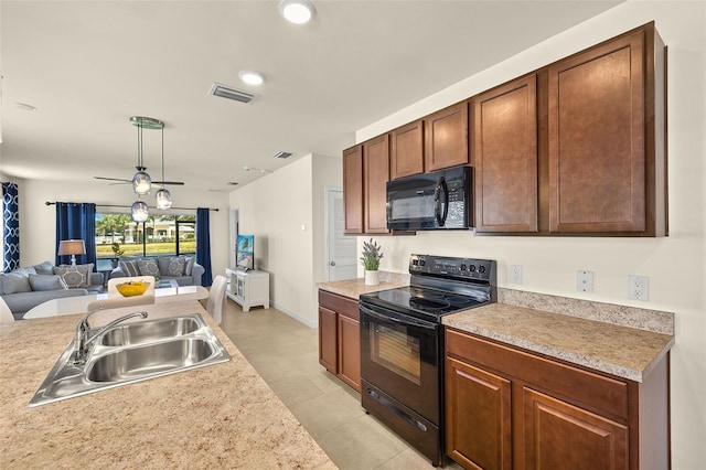 5358 Shell Mound Cir, Punta Gorda, FL 33982 - kitchen with black appliances, a sink, open floor plan, light countertops, and recessed lighting