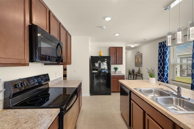5358 Shell Mound Cir, Punta Gorda, FL 33982 - kitchen featuring black appliances, a sink, hanging light fixtures, light countertops, and light tile patterned floors