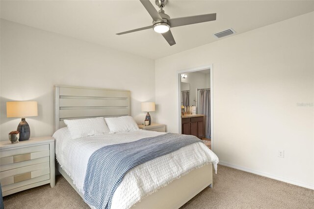 5358 Shell Mound Cir, Punta Gorda, FL 33982 - bedroom featuring light carpet, baseboards, ensuite bath, and a ceiling fan