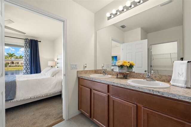 5358 Shell Mound Cir, Punta Gorda, FL 33982 - bathroom with connected bathroom, double vanity, tile patterned flooring, and a closet