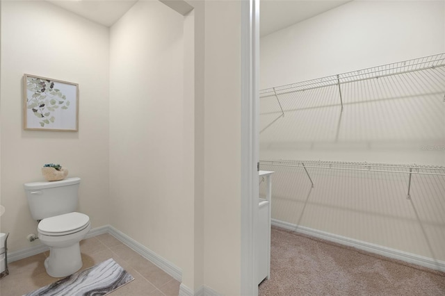 5358 Shell Mound Cir, Punta Gorda, FL 33982 - bathroom featuring toilet, baseboards, and tile patterned flooring