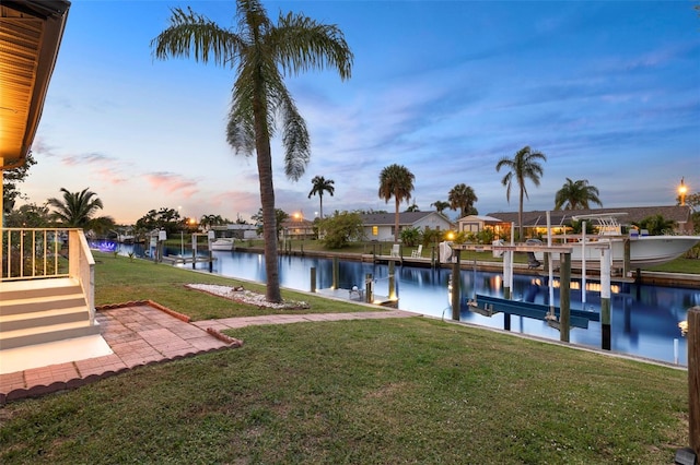 3203 Riverside Dr Unit B, Punta Gorda, FL 33950 - dock featuring boat lift, a water view, and a yard
