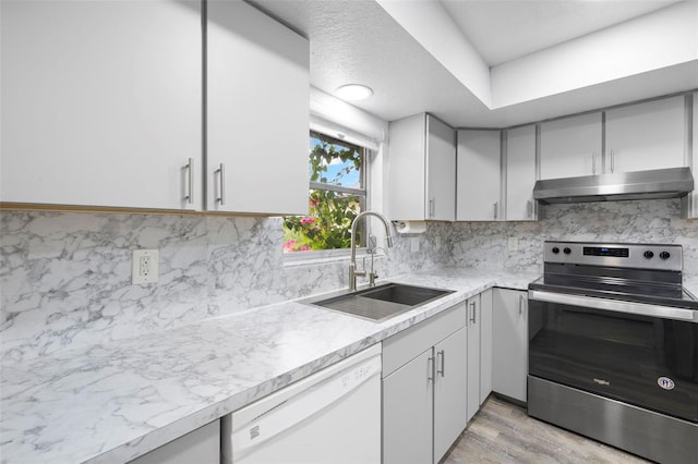 3203 Riverside Dr Unit B, Punta Gorda, FL 33950 - kitchen featuring stainless steel range with electric cooktop, under cabinet range hood, dishwasher, a sink, and light countertops