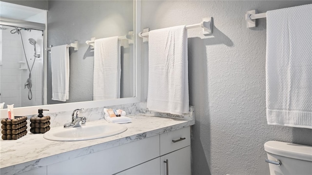 3203 Riverside Dr Unit B, Punta Gorda, FL 33950 - bathroom featuring toilet, vanity, a textured wall, and a shower