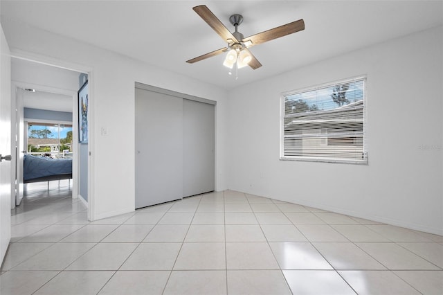 3203 Riverside Dr Unit B, Punta Gorda, FL 33950 - unfurnished bedroom featuring a closet, a ceiling fan, baseboards, and light tile patterned floors