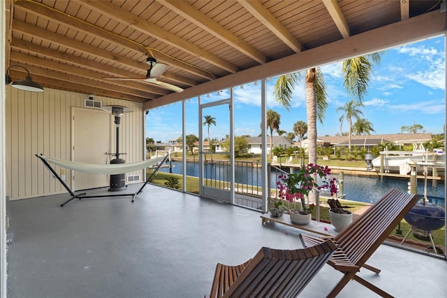 3203 Riverside Dr Unit B, Punta Gorda, FL 33950 - unfurnished sunroom with a water view, beamed ceiling, ceiling fan, and a residential view