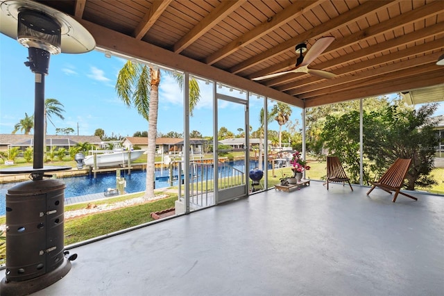 3203 Riverside Dr Unit B, Punta Gorda, FL 33950 - unfurnished sunroom featuring ceiling fan, a water view, and a residential view