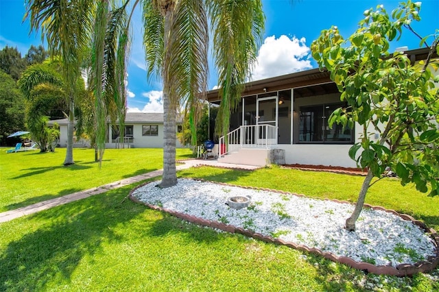 3203 Riverside Dr Unit B, Punta Gorda, FL 33950 - back of house with a sunroom and a lawn
