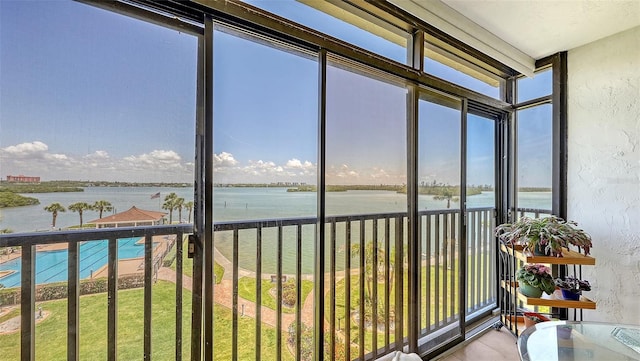 8897 Midnight Pass Rd Unit 407, Sarasota, FL 34242 - sunroom / solarium with a water view and plenty of natural light